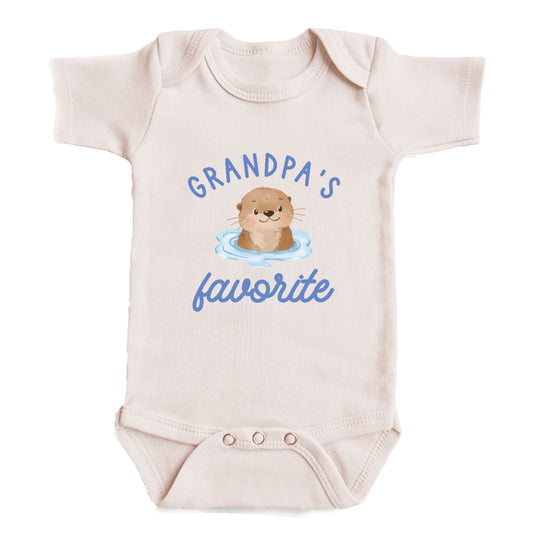 A baby onesie with a cute cartoon image of an otter and the text "GRANDPA'S FAVORITE" printed on it.