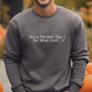 A man wearing a gray sweatshirt with the text "It's a Par-fect Day for Mini Golf!" printed on it.