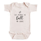 A baby onesie with the text "GET READY TO FALL IN LOVE" printed on it.