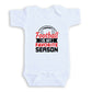 A white baby onesie with a graphic design and text printed on it.