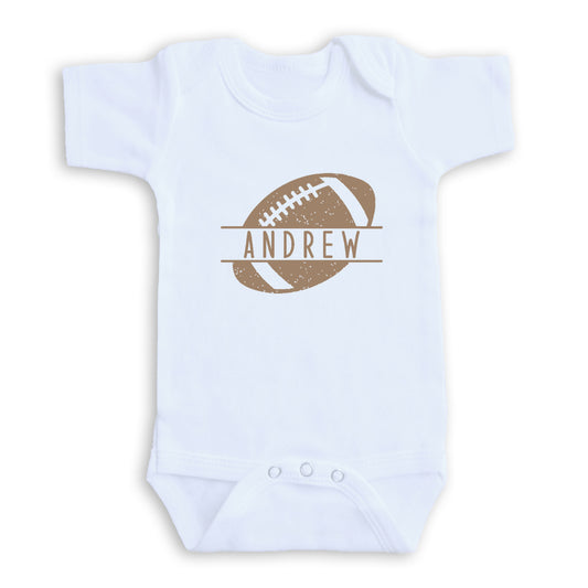 A white baby onesie with a football graphic and the name "ANDREW" printed on it.