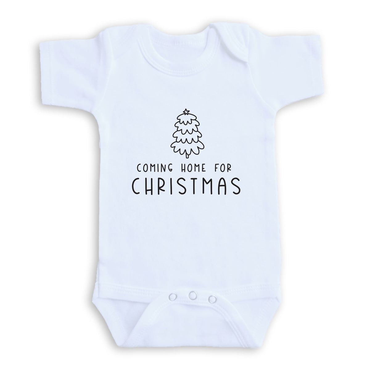 A white baby onesie with a Christmas tree graphic and the text "COMING HOME FOR CHRISTMAS" printed on it.