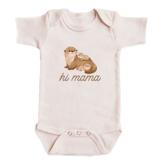 A baby onesie with an image of a mother otter and her two baby otters. The text below the image says "hi mama".