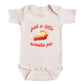 A baby onesie with a printed design of a pie and the text "Just a little sweetie pie" on it.