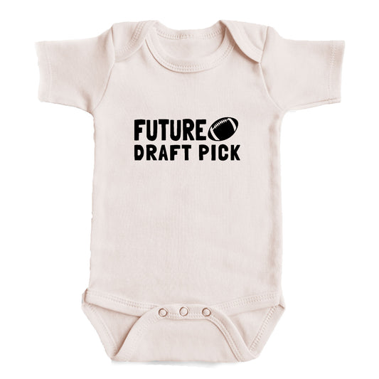 A baby onesie with the text "FUTURE DRAFT PICK" printed on it.