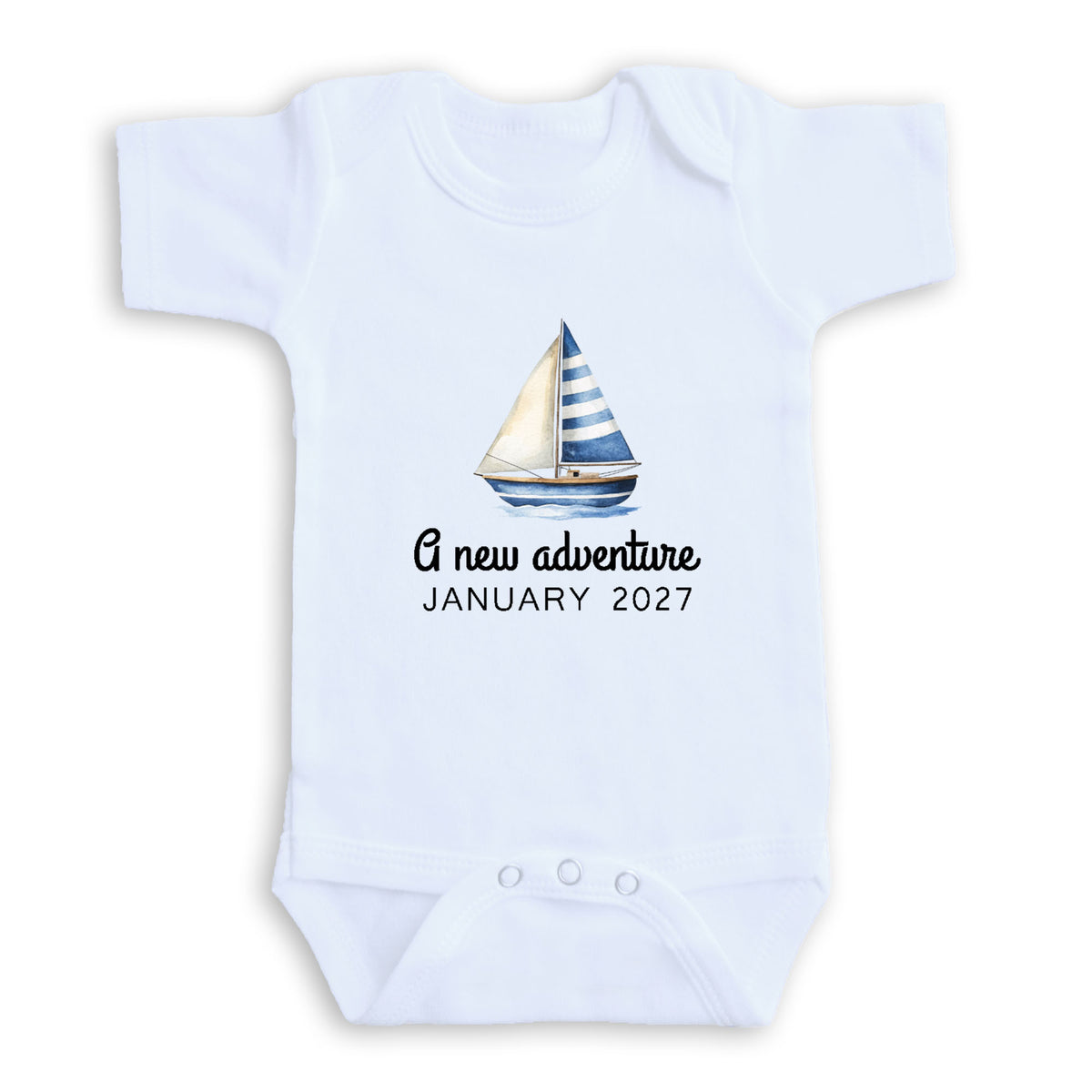 A white baby onesie with a sailboat graphic and text that reads "A new adventure JANUARY 2027".