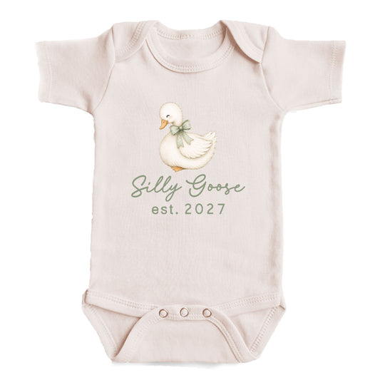 A baby onesie with a cartoon image of a duck and the text "Silly Goose est. 2027" printed on it.