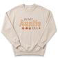 A beige sweatshirt with the text "IN MY AUNTIE ERA" printed on it.