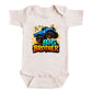 A white baby onesie with a graphic design featuring a blue monster truck and the text "BIG BROTHER" printed on it.