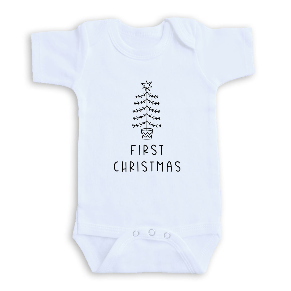 A white baby onesie with a black Christmas tree graphic and the text "FIRST CHRISTMAS" printed on it.
