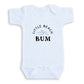A white baby onesie with the text "LITTLE BEACH BUM" printed on it.