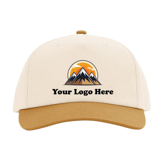 A white baseball cap with a graphic design featuring mountains and a sunset.