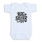 A white baby onesie with the text "BIG SISTER" printed on it.