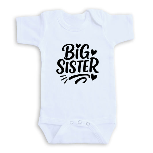 A white baby onesie with the text "BIG SISTER" printed on it.