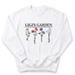 A white sweatshirt with a graphic design featuring four different flower illustrations and the text "GIGI'S GARDEN" printed on it.
