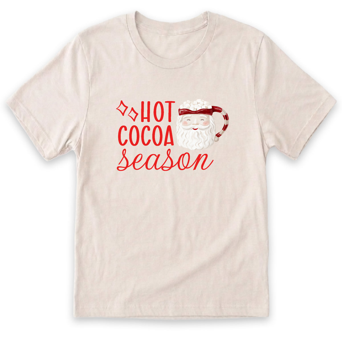 A beige t-shirt with a red graphic design that says "HOT COCOA SEASON" and features a Santa Claus or Christmas character.