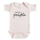A baby onesie with the text "CUTEST PUMPKIN" printed on it.