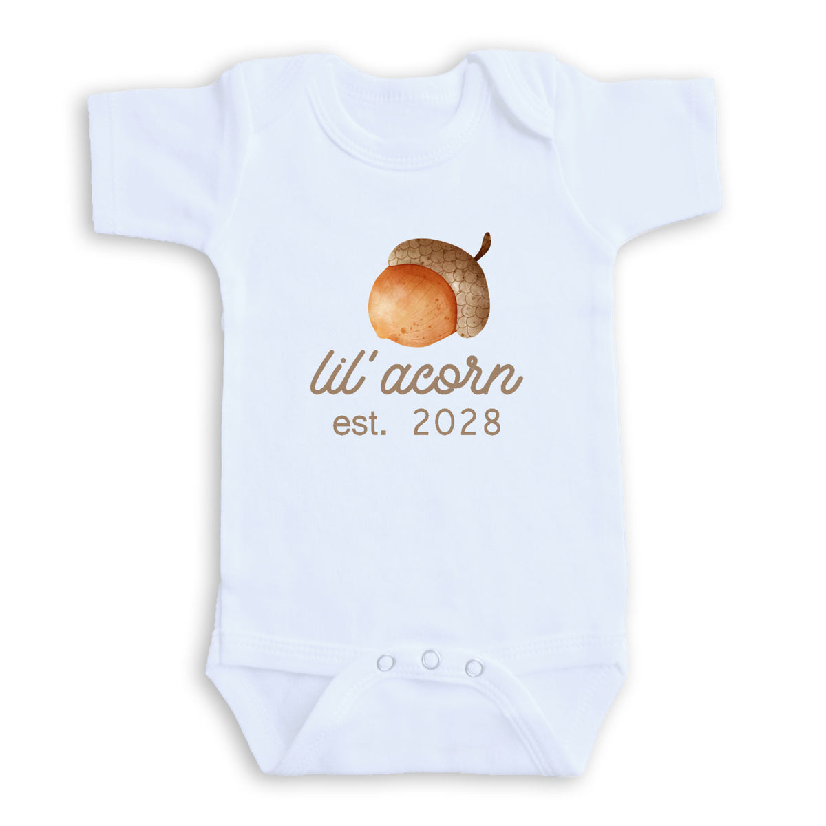 A white baby onesie with an acorn graphic and the text " lil' acorn est. 2028" printed on it.