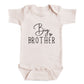 A baby onesie with the text "Big Brother" printed on it.