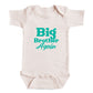 A baby onesie with the text "Big Brother Again" printed on it in teal and white colors.