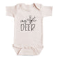 A baby onesie with the text "my deer" printed on it.