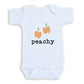 A white baby onesie with a graphic design of two peaches and the word "peachy" printed on it.