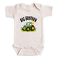 A baby onesie with a graphic of a tractor and the text "BIG BROTHER" printed on it.
