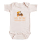 A baby onesie with an acorn and leaf design, along with the text "FALL IN LOVE November 2027".