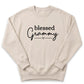 A beige sweatshirt with the text "blessed Grammy" printed on it.
