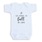 A white baby onesie with the text "GET READY TO FALL IN LOVE" printed on it.