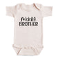 A baby onesie with the text "middle brother" printed on it.