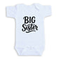 A white baby onesie with the text "BIG Sister" printed on it.