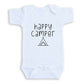A white baby onesie with the text "happy camper" printed on it.