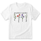 A white t-shirt with a graphic design featuring four different flowers and the text "grandma's garden" printed on it.