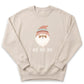 A beige sweater with a graphic of a smiling Santa Claus wearing a red and white striped hat, and the text "HO HO HO" printed below the Santa Claus image.