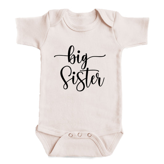 A baby onesie with the text "big Sister" printed on it.
