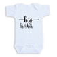 A white baby onesie with the text "big brother" printed on it.