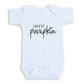 A white baby onesie with the text "CUTEST PUMPKIN" printed on it.