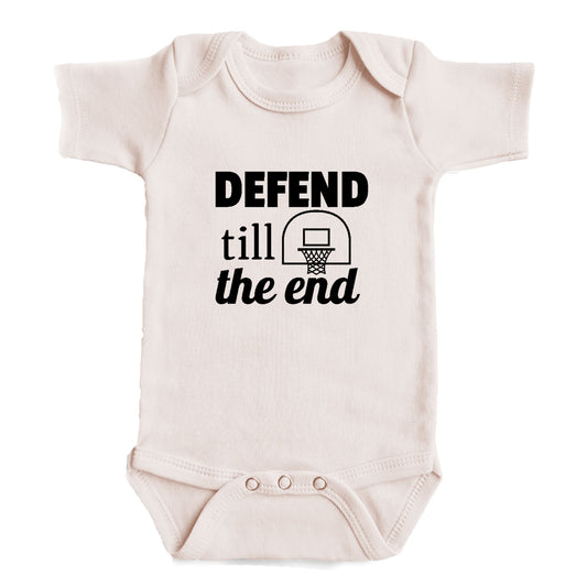 A baby onesie with the text "DEFEND TILL THE END" printed on it.