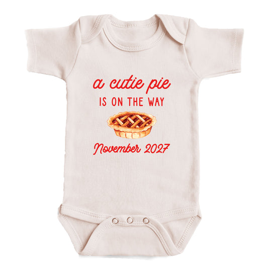 A baby onesie with a printed message on it.
