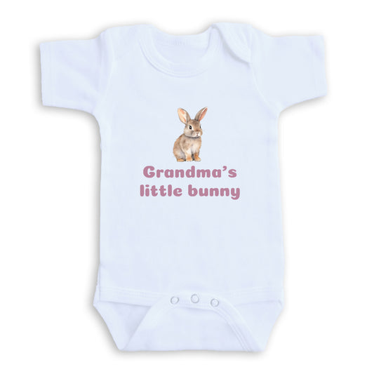 A white baby onesie with a printed image of a rabbit and the text "Grandma's little bunny" printed on it.