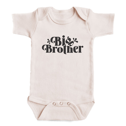 A baby onesie with the text "Big Brother" printed on it.