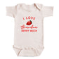 A white baby onesie with a red strawberry graphic and the text "I LOVE Grandma Berry Much" printed on it.