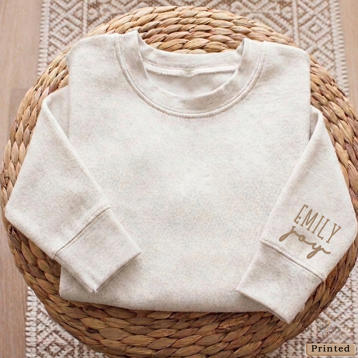 A white long-sleeved shirt is neatly folded and placed on a woven basket.