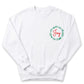 A white sweatshirt with a green wreath design and the word "Joy" written on it.