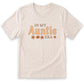 A beige t-shirt with the text "IN MY AUNTIE ERA" printed on it.
