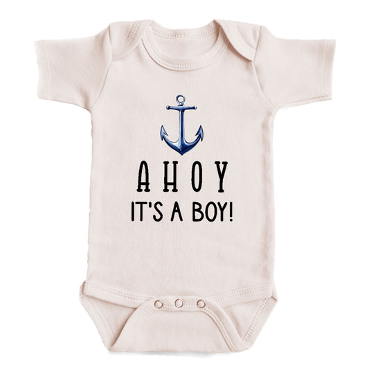 A baby onesie with the text "AHOY IT'S A BOY!" printed on it.