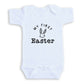 A white baby onesie with the text "My first Easter" printed on it.
