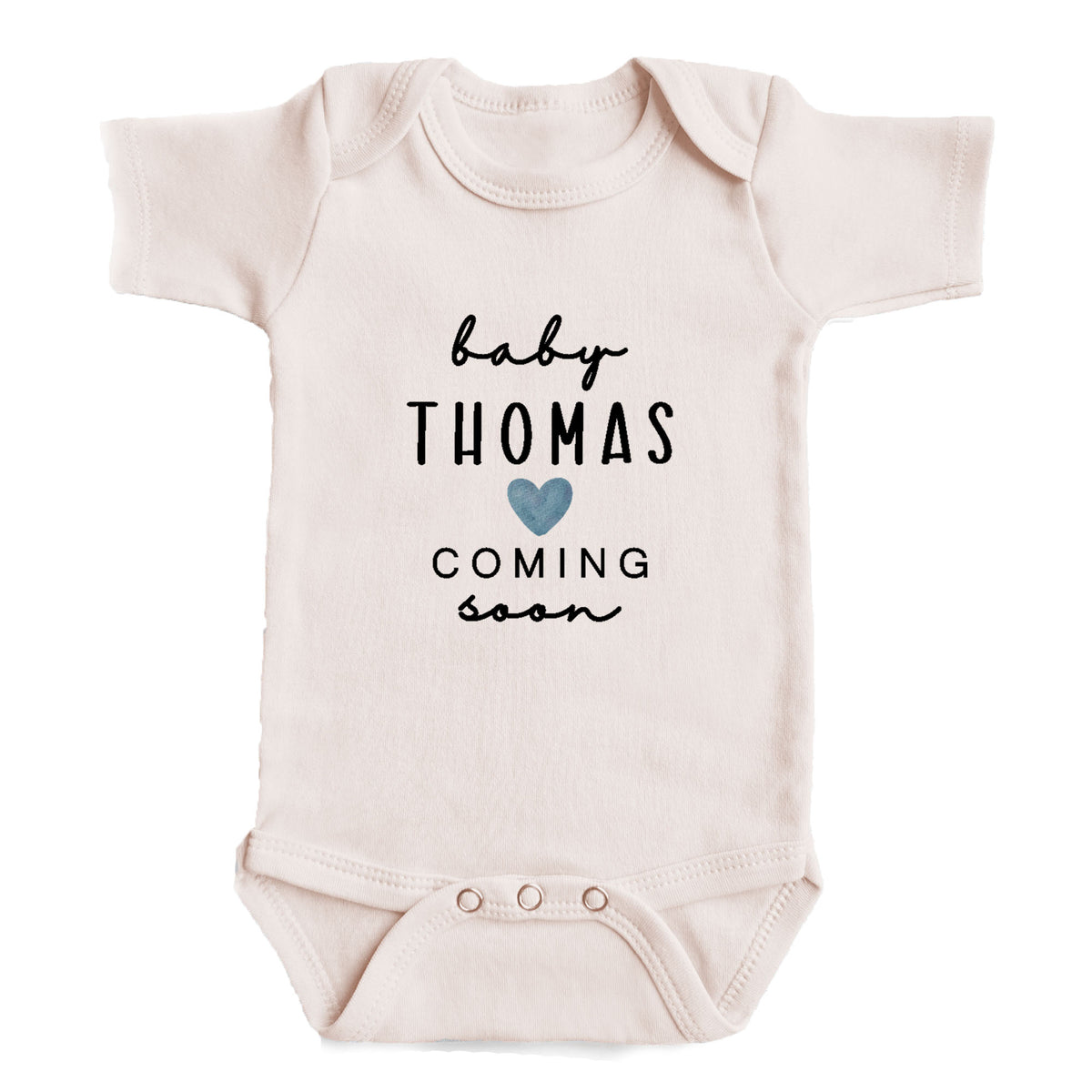 A baby onesie with the text "baby Thomas coming soon" printed on it.