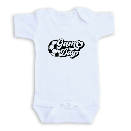 A white baby onesie with the text "Game Day" printed on it.